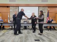 Police Sergeant William Kirby, Mayor Kristine Ford and Deputy Village Clerk Vivian Hofeld congratulate Officer Andrew Kolek.