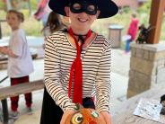 Halloween Party - Child in Zorro costume with decorated pumpkin