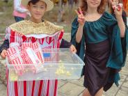 Halloween Party - Young boy and girl dressed up handing out popcorn