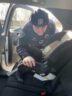 image of police officer installing car seat