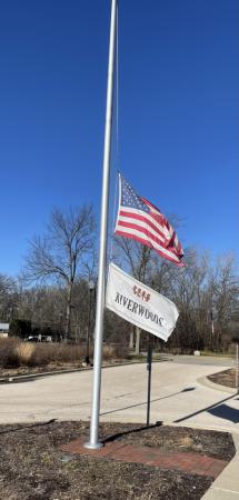 American Flag and Riverwoods Flag at Half Staff